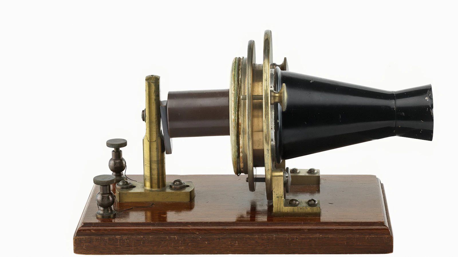 Alexander Graham Bell's experimental telephone of 1876, brass fittings and a black horn on a wooden base: a prototype built to answer one question, not to be the product
