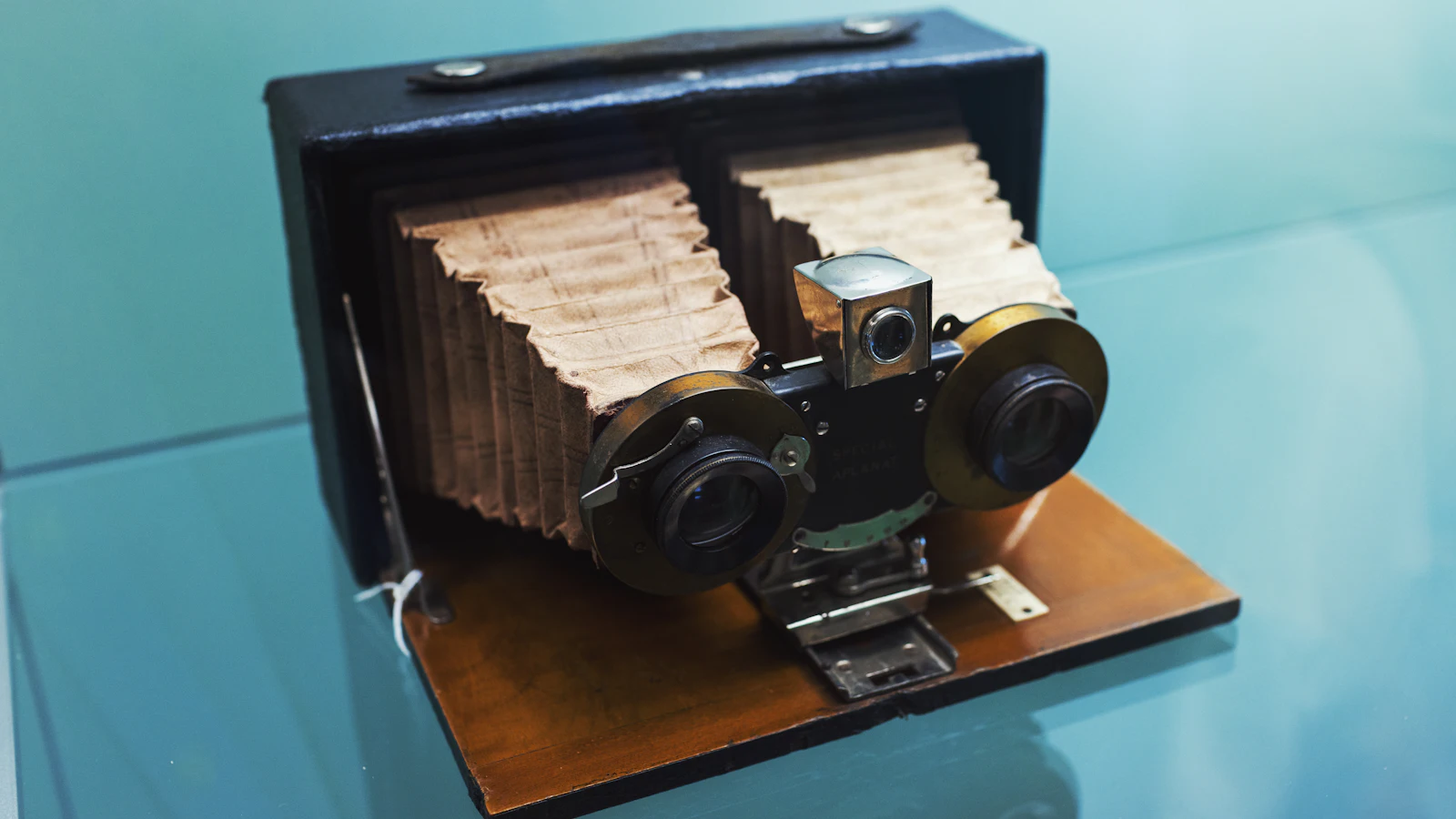 An antique stereo camera with twin paper bellows and two brass-ringed lenses side by side, built to take two near-identical pictures of one scene, as a visual test sets a new screenshot beside its baseline